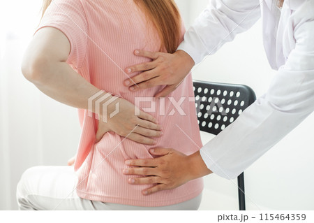 Female physiotherapists provide physical assistance to women patients with back injuries back massages for relaxation and muscle recovery in the rehabilitation center 115464359