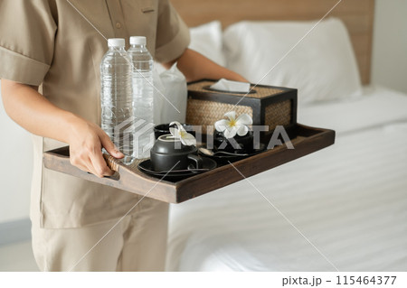 The housekeeper hotel cleans and arranges things in order. prepares to welcome VIP guests The housekeeper hotel cleans and arranges things in order. prepares to welcome VIP guests 115464377