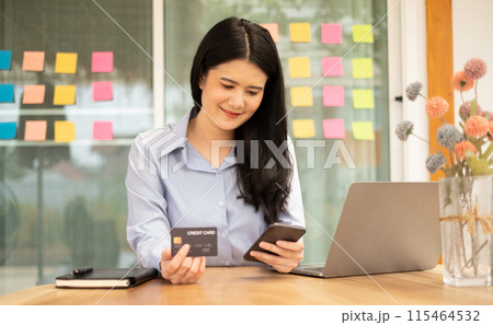 Asian girl shopping online holding credit and using smartphone enter their card number in the mobile phone app to purchase and payment in internet store Asian girl shopping online holding credit and using smartphone enter their card number in the mobile phone app to purchase and payment in internet store 115464532
