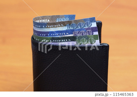 Liberian dollar in the black wallet 115465363