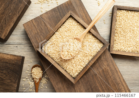 Brown rice in wooden box Brown rice in wooden box 115466167
