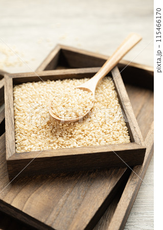 Brown rice in wooden box Brown rice in wooden box 115466170