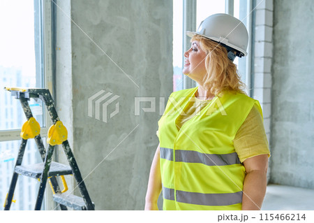 Technical profession woman in protective vest helmet working on construction Technical profession woman in protective vest helmet working on construction 115466214