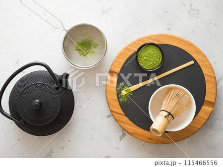 Japanese iron kettle with matcha green tea powder with whisk and spoon and bowl with sifte Japanese iron kettle with matcha green tea powder with whisk and spoon and bowl with sifte 115466556