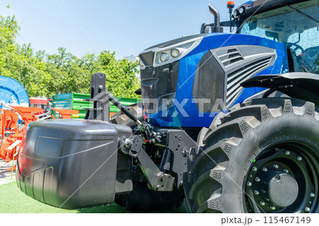 Modern blue agricultural tractor on a field. 115467149