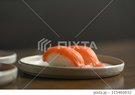 Nigiri sushi with salmon on ceramic plate. Japanese food style concept 115468032