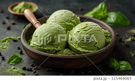 Scoops of pistachio ice cream metal container pistachio nuts on dark background 115469065