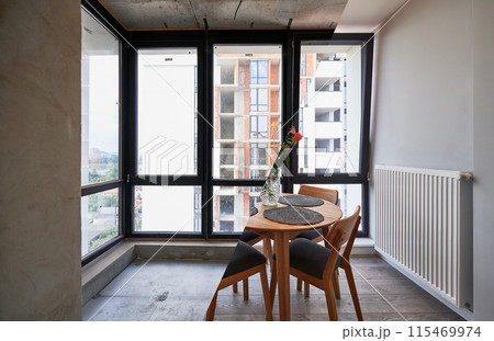 Photo collage of living room with large panoramic window before and after renovation. Old apartment with heating radiator and new renovated flat with flowers on table and elegant interior design. Photo collage of living room with large panoramic window before and after renovation. Old apartment with heating radiator and new renovated flat with flowers on table and elegant interior design. 115469974