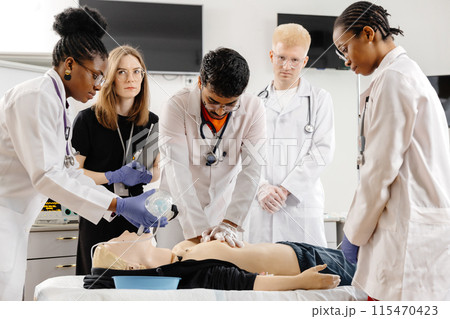 Medical Students Practicing CPR on a Dummy 115470423