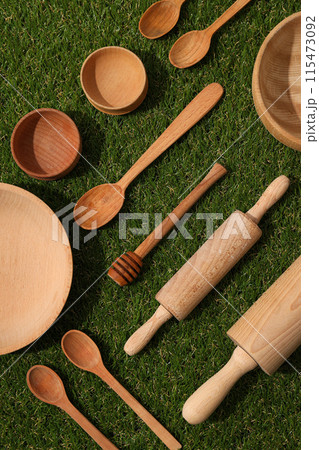 Reusable tableware made of wood on grass. Reusable tableware made of wood on grass. 115473092