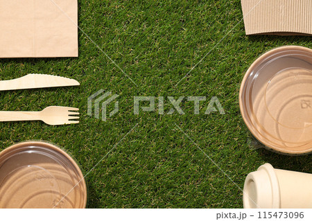Ecological packaging for food delivery, on the grass. Ecological packaging for food delivery, on the grass. 115473096