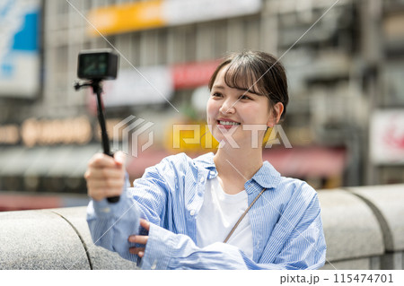 都会の繁華街で自撮り撮影をする若くて可愛い女性｜大阪観光イメージ｜大阪府道頓堀｜戎橋（えびすばし） 115474701