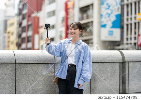 都会の繁華街で自撮り撮影をする若くて可愛い女性|大阪観光イメージ|大阪府道頓堀|戎橋(えびすばし) 都会の繁華街で自撮り撮影をする若くて可愛い女性|大阪観光イメージ|大阪府道頓堀|戎橋(えびすばし) 115474709