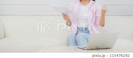 Young asian business woman working on laptop computer and looking graph and chart of report. Young asian business woman working on laptop computer and looking graph and chart of report. 115476292