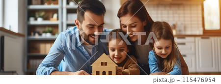 Parents and daughter playing with a wooden house model in the room. 115476954