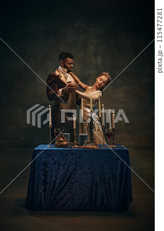 Regency era. Viscount and Viscountess in period attire having romantic dinner, dancing against retro green background 115477281