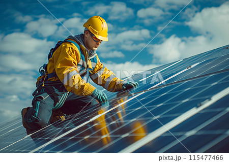 A technician is installing solar panels at a photovoltaic power station. 115477466