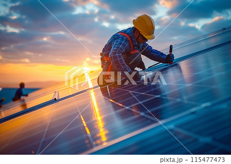 A technician is installing solar panels at a photovoltaic power station. 115477473