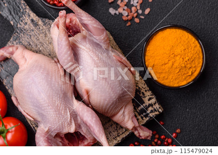 Whole raw quails with salt, spices and herbs on a dark concrete background 115479024