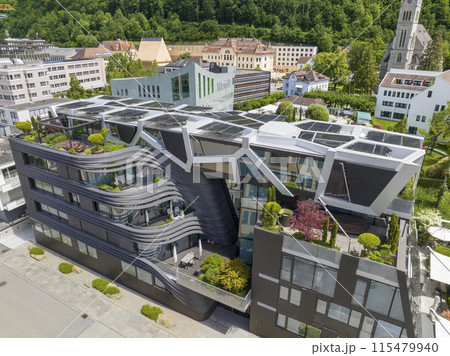 Modern Design Building with solar panel on roof top in Vaduz, Liechtenstein. Reuse and restore. Renewable energy concept Modern Design Building with solar panel on roof top in Vaduz, Liechtenstein. Reuse and restore. Renewable energy concept 115479940