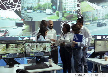 Team of diverse operators uniting forces to ensure express shipping, finding new routes to avoid urban traffic. Agency operating on CCTV security cameras footage and gps navigation. Team of diverse operators uniting forces to ensure express shipping, finding new routes to avoid urban traffic. Agency operating on CCTV security cameras footage and gps navigation. 115481338