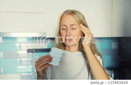 Sick upset woman looks at the pills, female patient does not want to take medicine standing at home 115481628