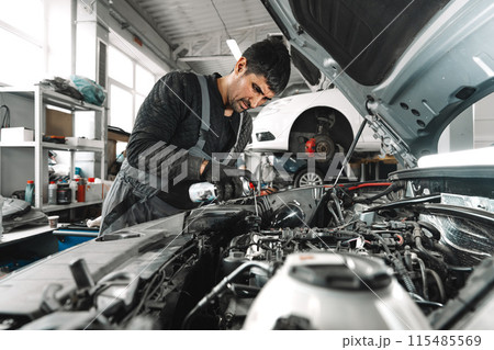 Mechanic examining car in auto car repair service center Mechanic examining car in auto car repair service center 115485569