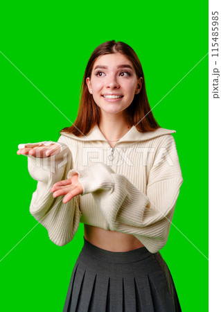 A woman wearing a white sweater and a black skirt stands in a neutral pose, the contrast of her outfit colors making a striking visual impact. A woman wearing a white sweater and a black skirt stands in a neutral pose, the contrast of her outfit colors making a striking visual impact. 115485985