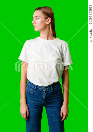 Young Woman in White Shirt Posing for Picture against green background 115485998