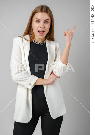 Excited Young Woman in Stylish Outfit Surprised Expression 115486008