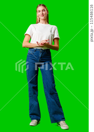 Young Woman in White Shirt Posing for Picture against green background 115486116