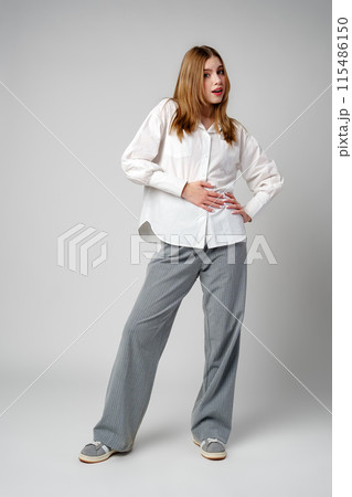 Young Woman in White Shirt Posing for Picture 115486150