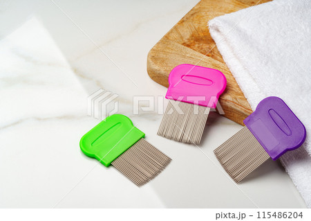 Anti lice combs and towel on white background 115486204