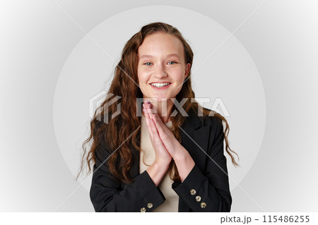 Startled Woman With Surprised Expression on gray background Startled Woman With Surprised Expression on gray background 115486255