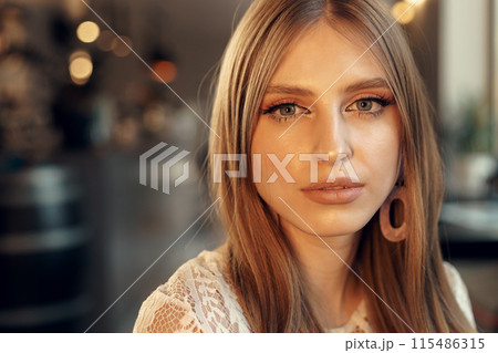 Beautiful female model portrait in a cafe 115486315