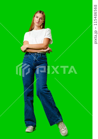 Young Woman in White Shirt Posing for Picture against green background 115486568