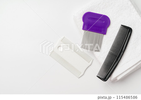 Anti lice combs and towel on white background Anti lice combs and towel on white background 115486586