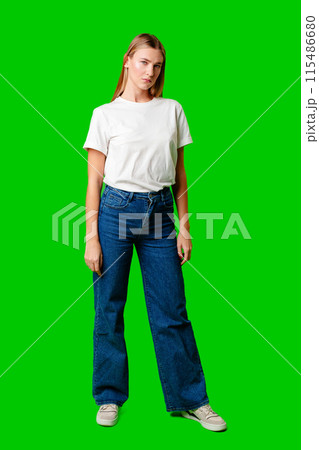 Young Woman in White Shirt Posing for Picture against green background Young Woman in White Shirt Posing for Picture against green background 115486680