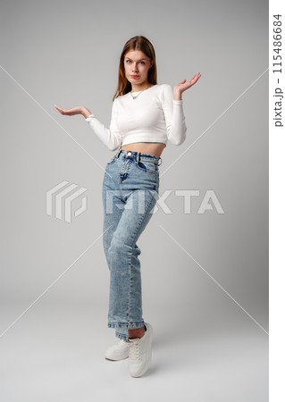 Young Woman in Blue Top Holding Out Hands 115486684