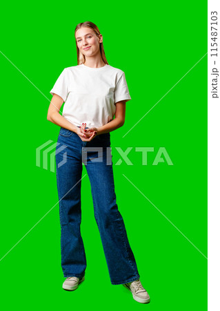 Young Woman in White Shirt Posing for Picture against green background Young Woman in White Shirt Posing for Picture against green background 115487103