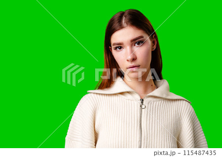 A woman wearing a white sweater and a gray skirt stands in a casual pose, showcasing her stylish outfit. A woman wearing a white sweater and a gray skirt stands in a casual pose, showcasing her stylish outfit. 115487435