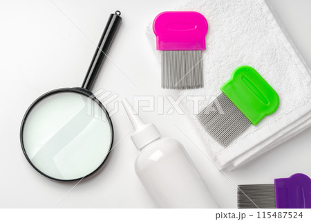 Medicine, lice comb and magnifying glass isolated on white 115487524