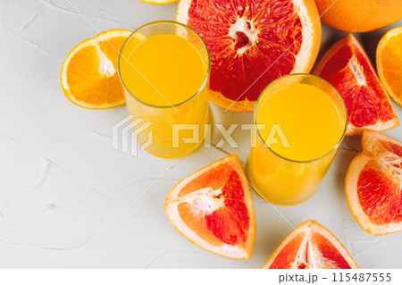 Sliced citrus fuits juicy on table close up 115487555