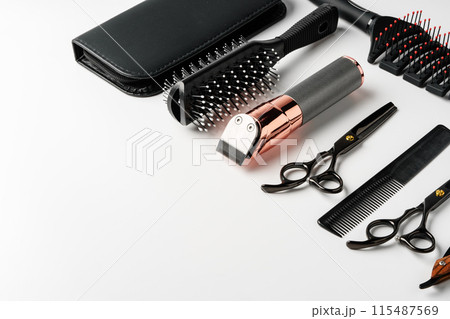 Set of barber tools for haircut on gray background flat lay Set of barber tools for haircut on gray background flat lay 115487569