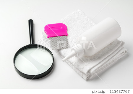 Cosmetic products, lice comb and magnifying glass isolated on white Cosmetic products, lice comb and magnifying glass isolated on white 115487767