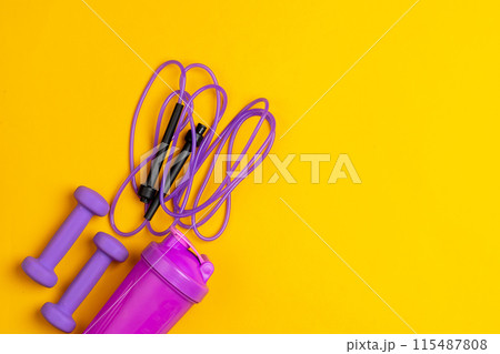 Assortment of sport equipment on yellow background, top view Assortment of sport equipment on yellow background, top view 115487808