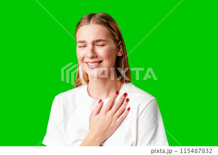 Portrait of an upset young casual girl against green background 115487832