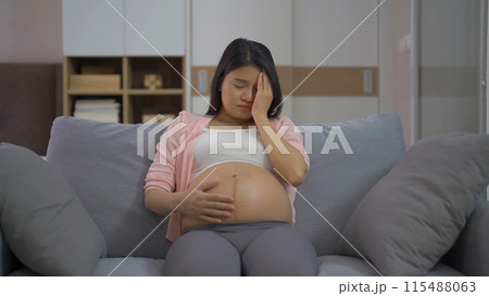 Depressed lonely Asian pregnant divorce woman in bedroom at home. Having a baby. Family people lifestyle. Mom. Depressed lonely Asian pregnant divorce woman in bedroom at home. Having a baby. Family people lifestyle. Mom. 115488063