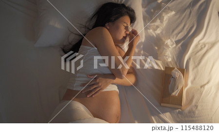 Depressed lonely Asian pregnant divorce woman in bedroom at home. Having a baby. Family people lifestyle. Mom. Depressed lonely Asian pregnant divorce woman in bedroom at home. Having a baby. Family people lifestyle. Mom. 115488120