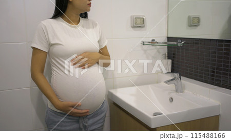 A portrait of happy Asian pregnant woman in toilet,  bathroom or restroom with basin. Having a baby. Family people lifestyle. Mom love. 115488166